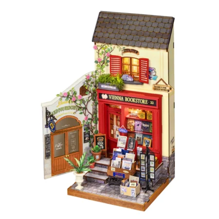 Miniature diorama of a Viennese bookstore with a red storefront, window display, and plants outside.
