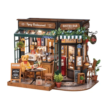 Miniature bistro storefront with outdoor seating, teddy bear customer, and plants on display