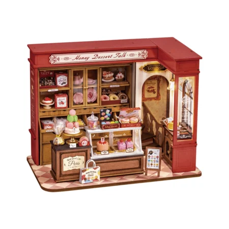 Miniature red storefront bakery display filled with toy pastries and confections