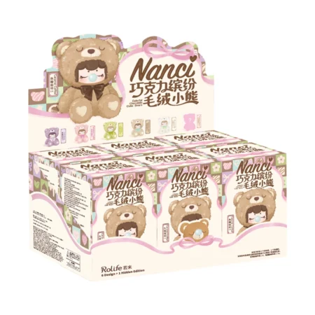 Display carton packaging for 'Nanci' chocolate bear candies with a cute teddy bear mascot and pastel pastel-colored boxes on a counter display.
