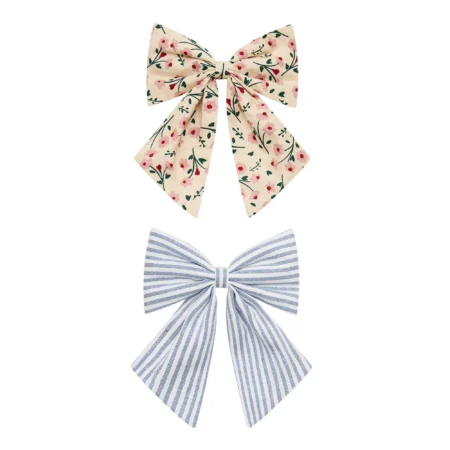 Two decorative fabric bows: a cream bow with pink flowers at the top and a blue-and-white striped bow at the bottom.