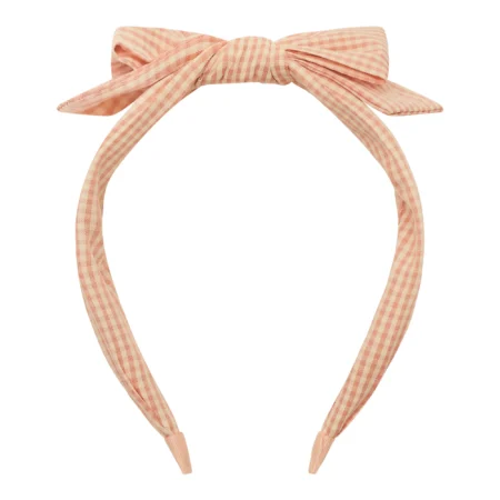 Pink gingham fabric bow headband with a knotted center and trailing tails, close-up detail from a hair accessory