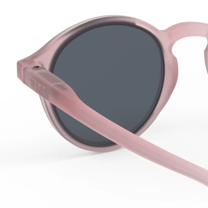 255_699db063d402e_700x700r Close-up of pink round sunglasses with dark lenses, angled to show the frame and temple. Option 1: Pink eyewear close-up.