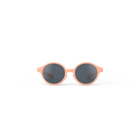 Peach-pink round sunglasses with dark lenses on a white background.