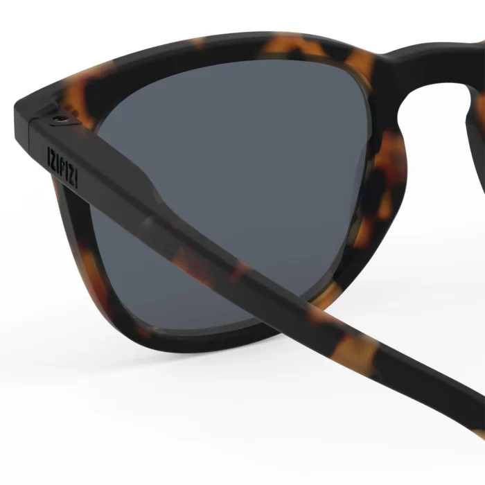 300_699db2ecca542_700x700r Close-up of tortoiseshell sunglasses with dark lenses, shown from the side