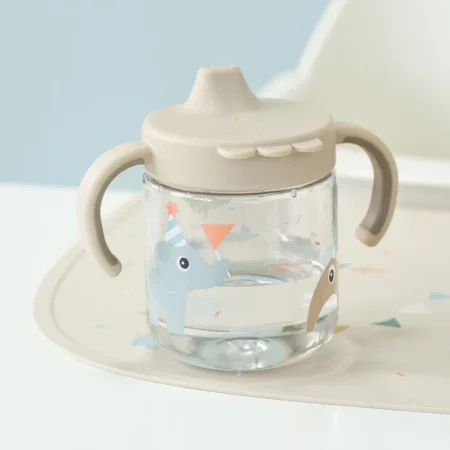 Baby sippy cup with two curved handles and a beige lid, featuring a blue elephant with a party hat.