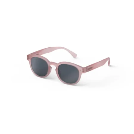 Pink plastic sunglasses with dark gray lenses, shown angled to reveal the frame's shape and color on a white background.