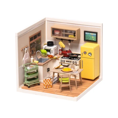 Toy kitchen diorama with a yellow retro fridge, stove, sink, and small dining table set for a pretend meal.