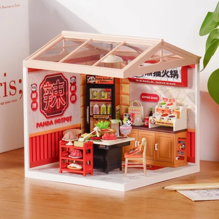 Miniature panda hotpot restaurant playset inside a glass-roofed room, with a stove, counter, shelves, and a small dining table.