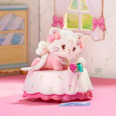 Pastel pink and white kitten figurine with bows sits on a frilly pink tablecloth in a pastel bedroom scene