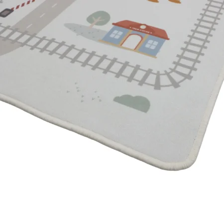 Illustration of a small blue train station with a red roof on a light rug, surrounded by stylized tracks and a tree (play mat design).